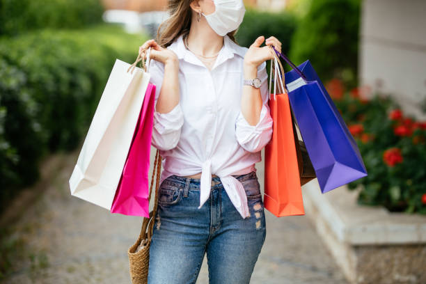 istock Woman wearing protective face mask and shopping 1253532213