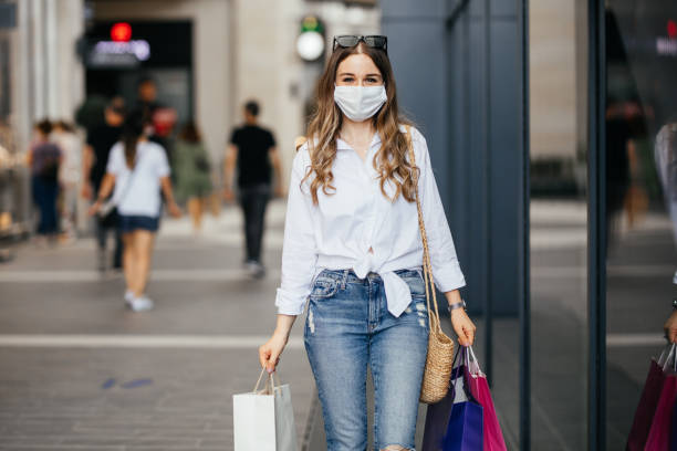 istock Woman wearing protective face mask and shopping 1253534305
