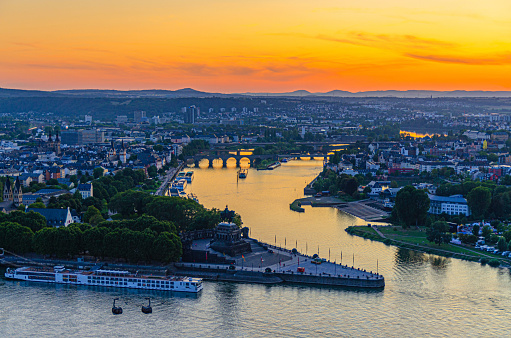 Aerial panoramic view of Koblenz historical city centre and joining Rhine and Moselle rivers, evening twilight view of amazing colorful orange sunset on horizon, Rhineland-Palatinate state