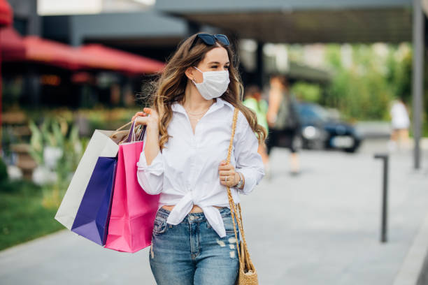 istock Woman wearing protective face mask and shopping 1253535488