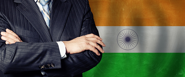 Male hands against indian flag background, business, politics and education in India concept