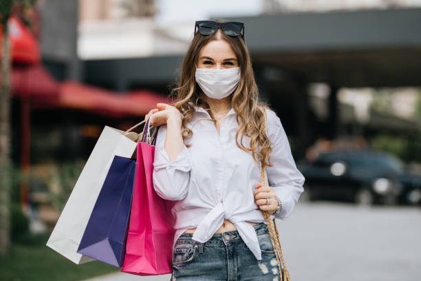 istock Woman wearing protective face mask and shopping 1253535606