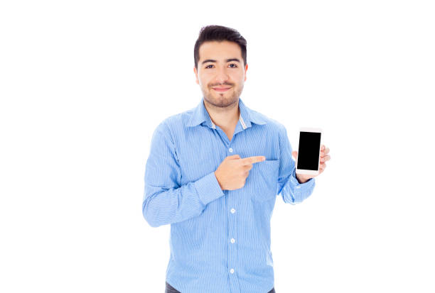 istock Handsome man pointing at smartphone's screen while smiling at camera 1253535855