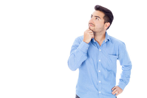 istock Young man looking up daydreaming 1253535866