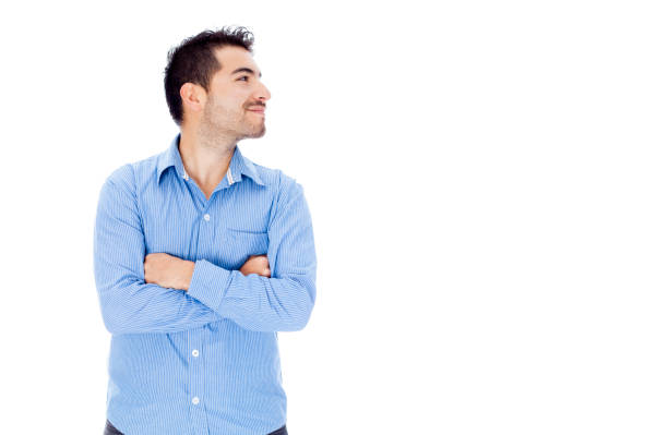 istock Handsome young man looking to his side with arms crossed 1253535881