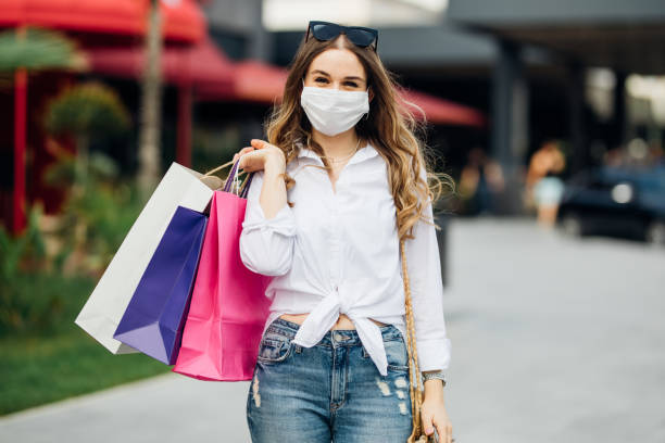istock Woman wearing protective face mask and shopping 1253536076