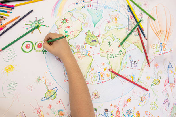 istock Boy drawing planet Earth and coronavirus motives 1253536699