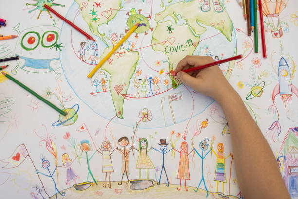 istock Boy drawing planet Earth and coronavirus motives 1253536760