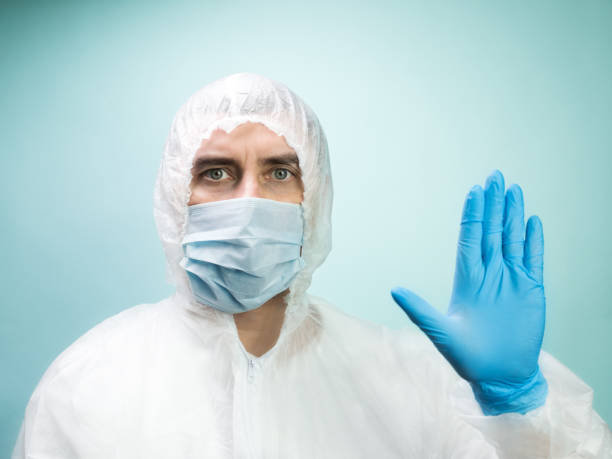 istock Man in protective suit and medical mask 1253536861