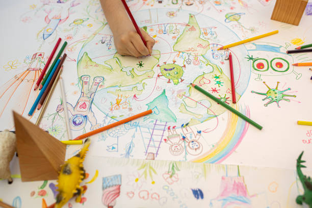 istock Boy drawing planet Earth and coronavirus motives 1253536929