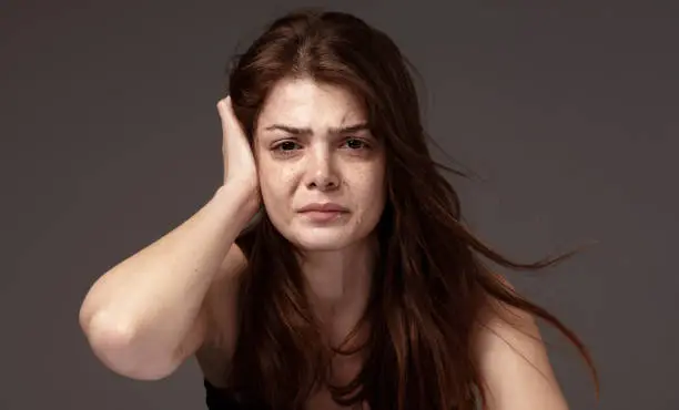 Photo of Freckled beautiful young woman crying.