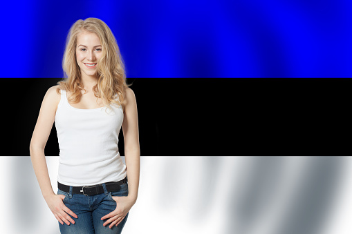 Estonia. Happy girl on Estonian flag background
