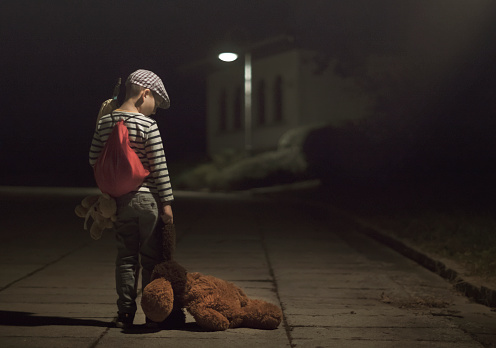 Little Runaway or Homeless kid with sack luggage and Teddy Bear. Homelessness, Leaving home, Divorce concept