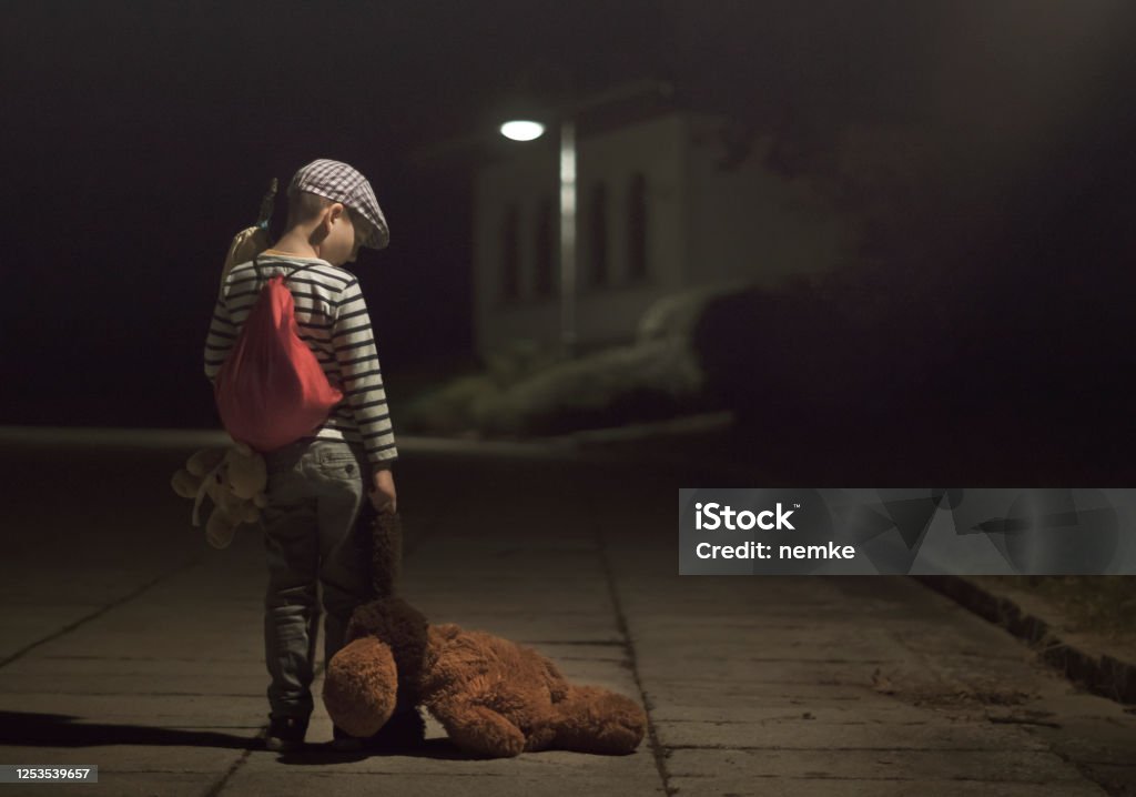 Little Runaway kid with sack luggage and Teddy Bear Little Runaway or Homeless kid with sack luggage and Teddy Bear. Homelessness, Leaving home, Divorce concept Child Stock Photo