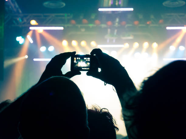 istock Filming concert on smart phone 1253541409