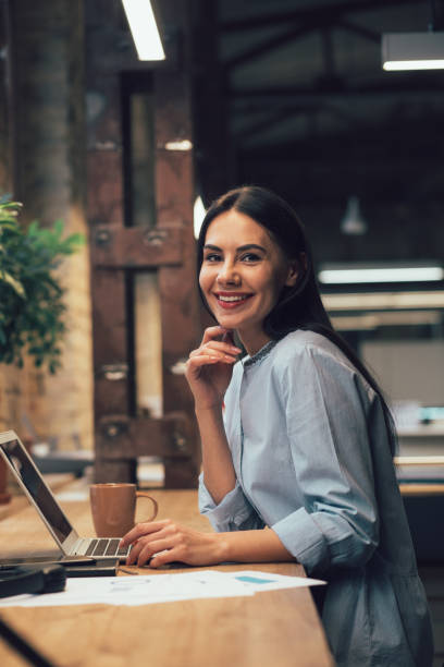 istock Beautiful office employee posing at her comfortable workplace 1253542010