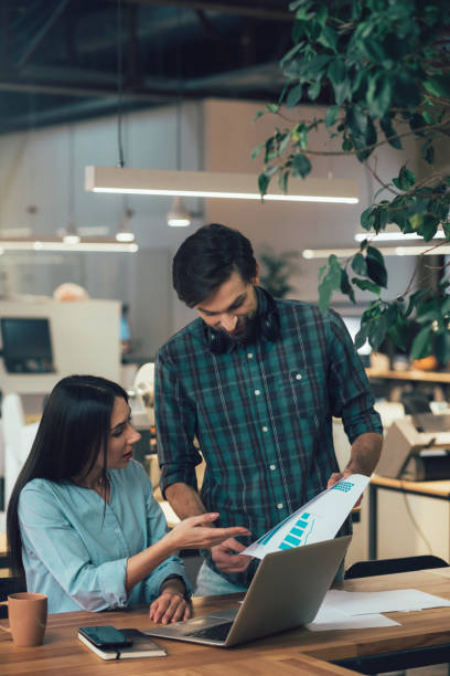 istock Clever young coworkers discussing their new project 1253542410