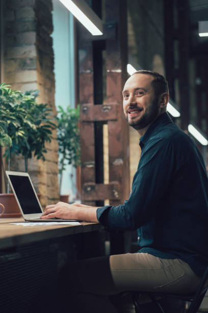 istock Handsome man under the lamps in stylish office alone 1253543011