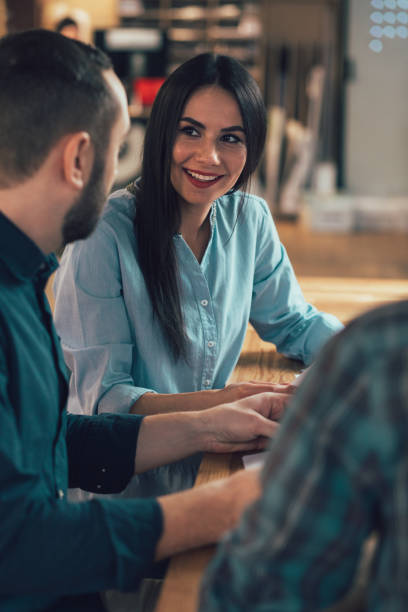 istock Beautiful cheerful lady sitting with colleagues and smiling 1253543341