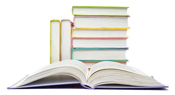 Pile of books with one open, isolated on a white background.