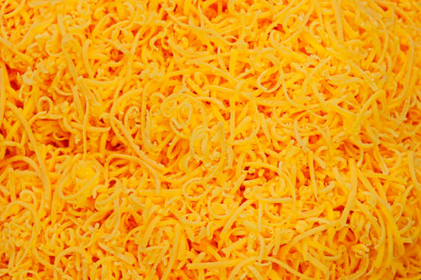 istock grated red cheddar cheese in close up 1253546353