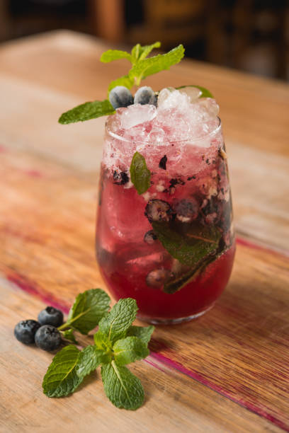 istock strawberry mojito cocktail drink with mint, on wooden table background 1253546387