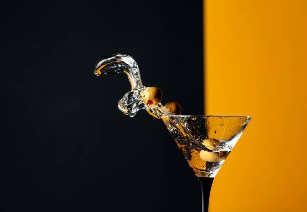 istock Martini with green olives splash. 1253549744