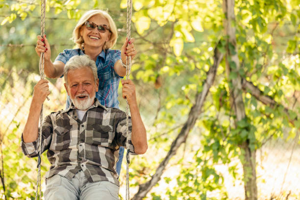 istock Senior couple having fun on a swing 1253550861