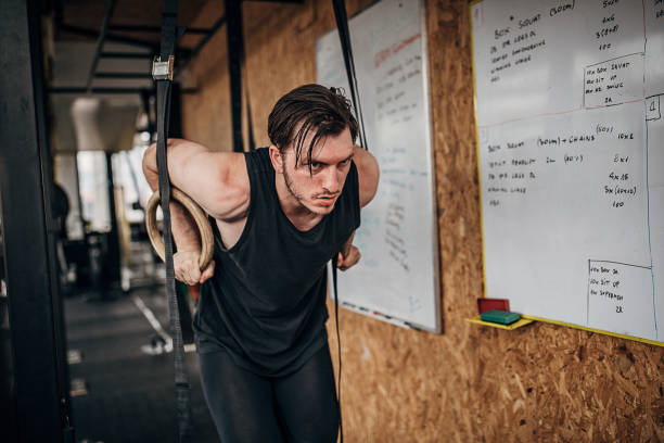 istock Man exercising on gymnastic rings in gym 1253554057