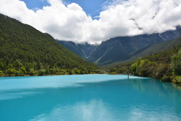 istock blue lake and white clouds in the mountains 1253554867
