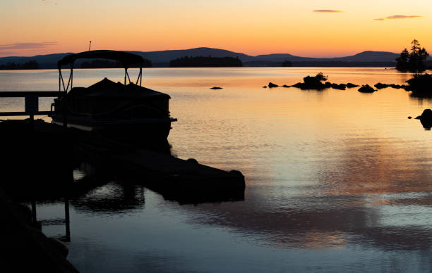 istock Pontoon Silhouette in Mountain Lake 1253556024