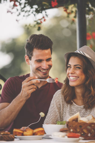 istock Couple on a date tasting each others food 1253559083