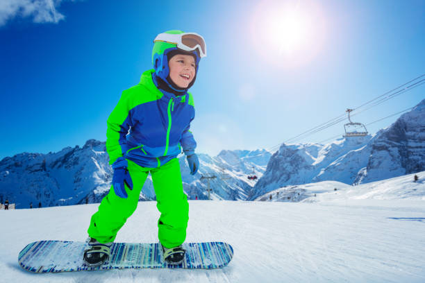 istock Snowboard boy move fast on the ski resort hill 1253559335