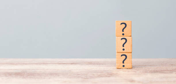 istock Question marks on the table written in a row on cubes. Frequently asked questions concept 1253559496