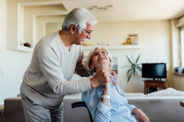 istock Elderly man caring about his disabled wife 1253559725