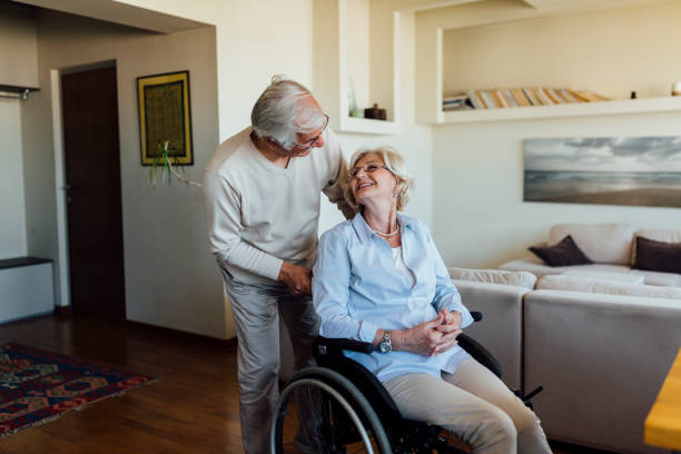 istock Elderly man caring about his disabled wife 1253559726
