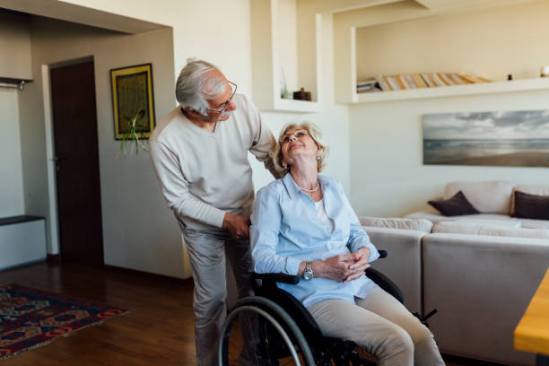 istock Elderly man caring about his disabled wife 1253559736
