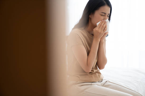 istock An Asian woman is sick and getting cold with running nose. 1253560627