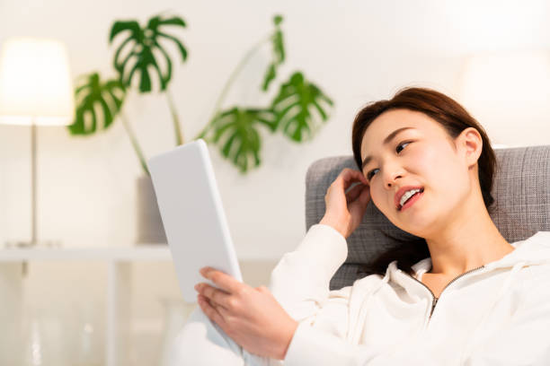 istock asian woman to see a tablet computer 1253561673