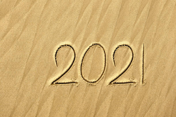 istock Inscription 2021 on the sand 1253566547
