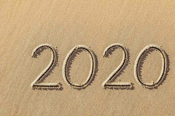 istock new year 2020 written in sand 1253566675