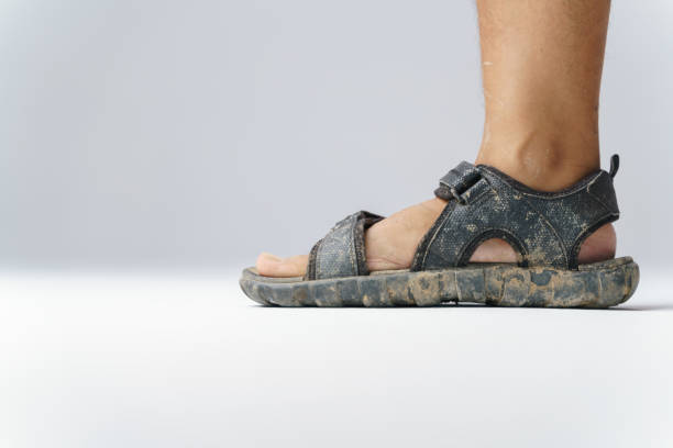 Dirty feet with sandal shoes full of dirt from trekking or off road walk