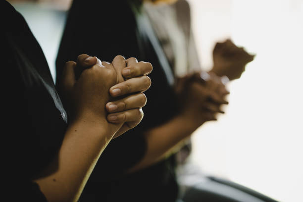 istock Three people pray and praising God together 1253571331
