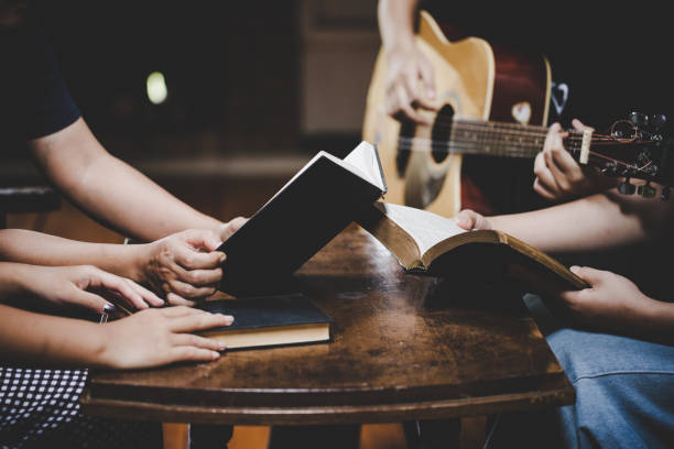istock Group of people praying worship believe 1253571337
