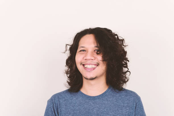 istock Asian man long hair smiling 1253574415