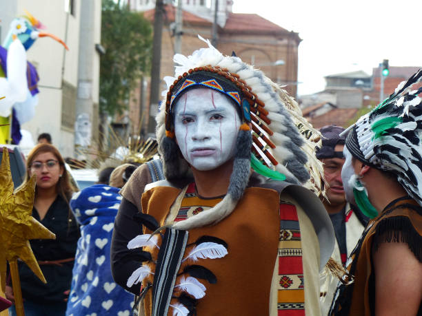 Cuenca, Ecuador - January 6, 2020: Traditional parade or masquerade on Day of the Innocents in Cuenca. Young man dressed as native american indian