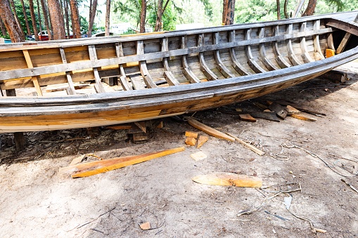 Repairing old wooden boat, traditional Thai style boat, outdoor day light, Asian style boat