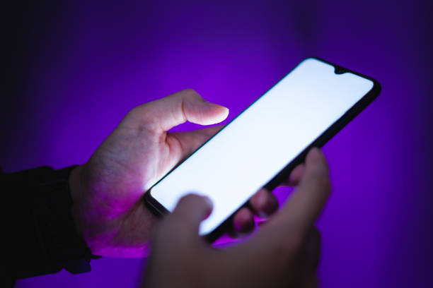 istock hand holds smartphone in the nightclub 1253576078