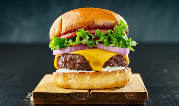 istock thick cheeseburger with american cheese, lettuce tomato and onion 1253576706