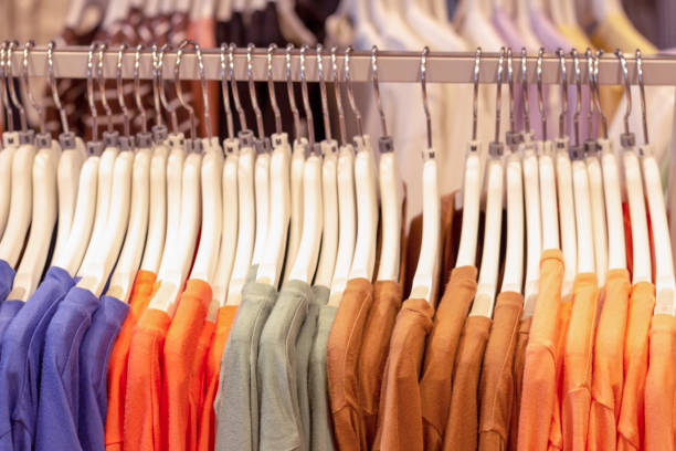 istock Multicolored things of pastel shades hang on white shoulders, side view 1253576877